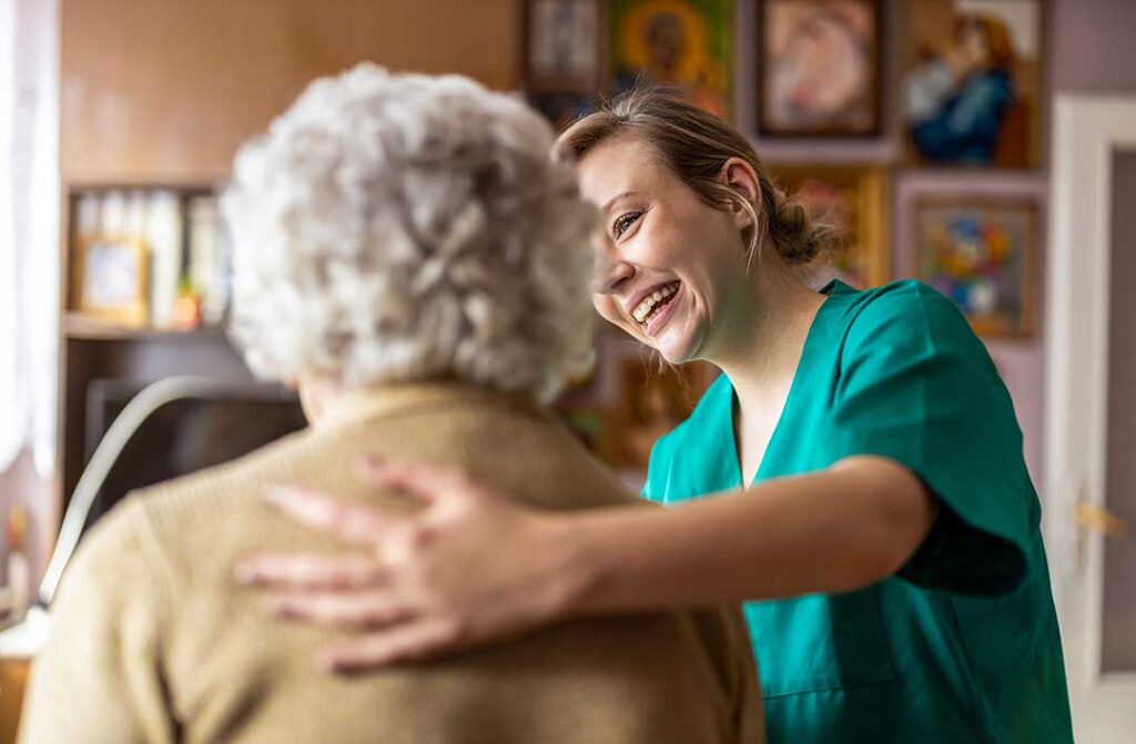Older adults and family members reviewing assisted living care notes in a bright apartment living room.