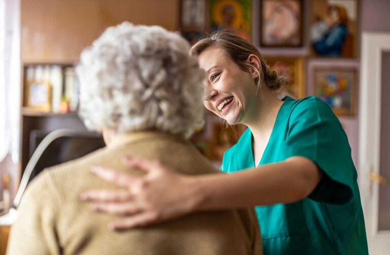 Older adults and family members reviewing assisted living care notes in a bright apartment living room.